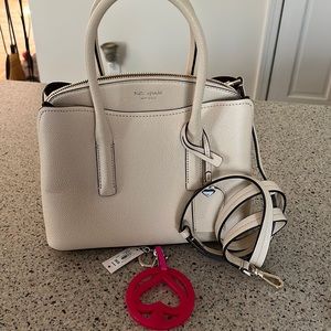Such a cute bag! Never used with tags. Comes with key chain and shoulder strap.
